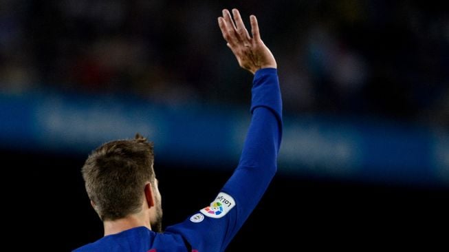 Gerard Pique merayakan setelah golnya setelah mencetak gol selama pertandingan sepak bola liga Spanyol FC Barcelona melawan Valencia CF di stadion Camp Nou di Barcelona pada 14 September 2019. PAU BARRENA / AFP
