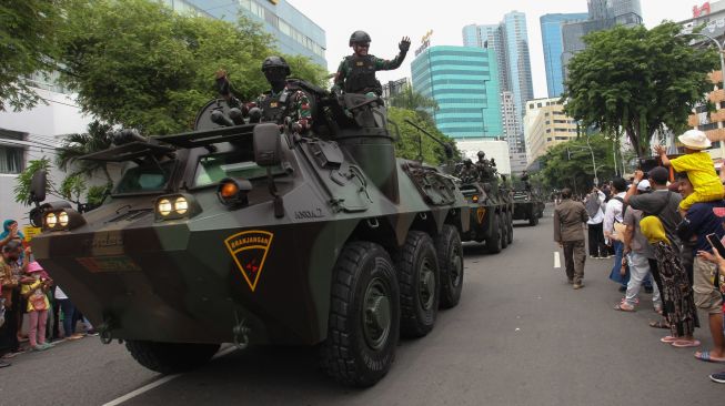 Warga menyaksikan konvoi kendaraan tempur saat Parade Surabaya Juang di Surabaya, Jawa Timur, Minggu (6/11/2022). [ANTARA FOTO/Didik Suhartono/foc]
