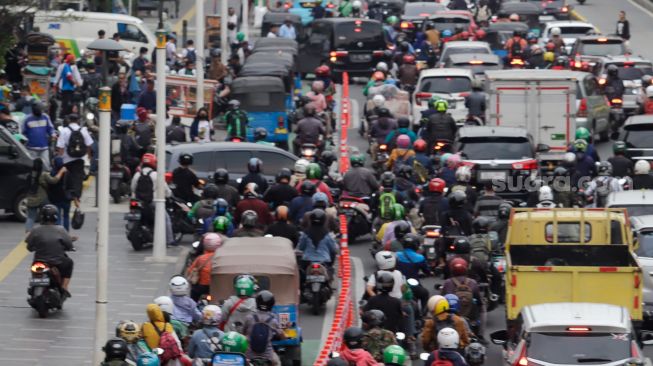 Sejumlah kendaraan bermotor menaiki trotoar saat melintas di Jalan Salemba Raya, Jakarta Pusat, Senin (7/11/2022). [Suara.com/Alfian Winanto]