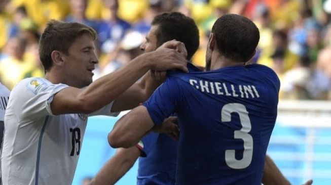 Pemain Italia Giorgio Chiellini menunjukkan bekas gigitan Luis Suarez dalam laga Grup D Piala Dunia 2014 kontra Uruguay yang berlangsung di Natal, 24 Juni 2014. [AFP]