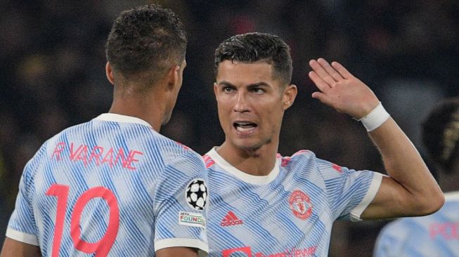 Striker Manchester United Cristiano Ronaldo (kanan) berbicara dengan Raphael Varane (kiri) selama laga lanjutan Grup F Liga Champions antara Young Boys vs Manchester United di stadion Wankdorf di Bern, pada 14 September 2021.SEBASTIEN BOZON/AFP.