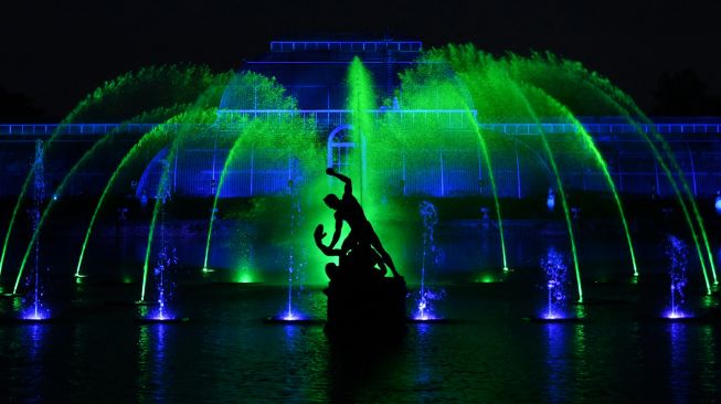  Lampu menerangi Palm House saat perayaan natal Kew atau "Christmas at Kew" di Kew Gardens, barat daya London, Inggris, Selasa (15/11/2022). [Daniel LEAL / AFP]
