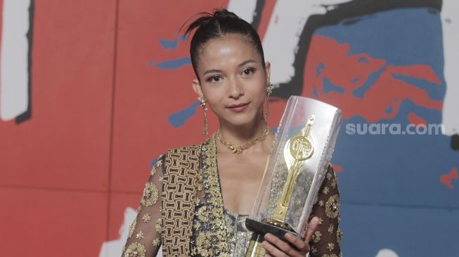 Putri Marino menunjukan Piala Citra sebagai Pemeran Pendukung Perempuan Terbaik dalam Festival Film Indonesia (FFI) 2022 di Jakarta, Selasa (22/11). {Suara.com/Oke Atmaja]
