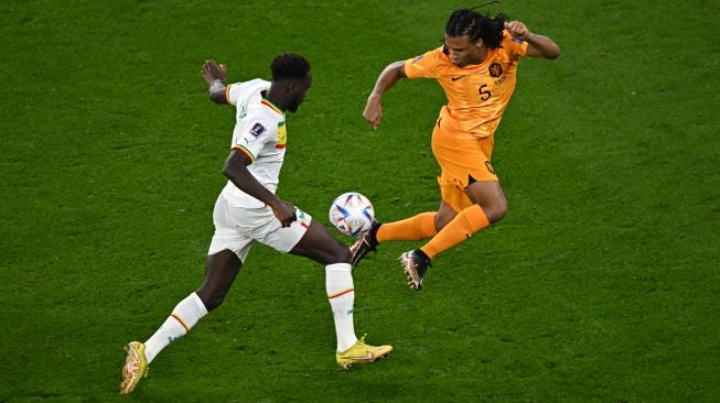 Penyerang Senegal Boulaye Dia (kiri) berebut bola dengan bek Belanda Nathan Ake (kanan) saat pertandingan sepak bola Grup A Piala Dunia 2022 antara Senegal dan Belanda di Stadion Al-Thumama di Doha, Qatar, Senin (21/11/2022). [MANAN VATSYAYANA / AFP]