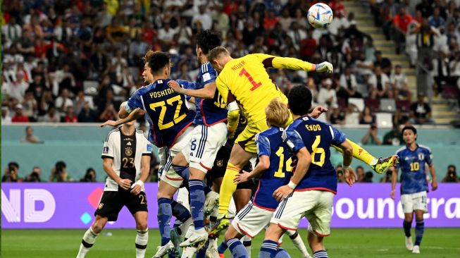 Kiper Jerman Manuel Neuer (Tengah) dan para pemain melompat untuk merebut bola di area gawang Jerman saat pertandingan sepak bola Grup E Piala Dunia Qatar antara Jerman dan Jepang di Stadion Internasional Khalifa di Doha, Qatar, Rabu (23/11/2022). [INA FASSBENDER / AFP]