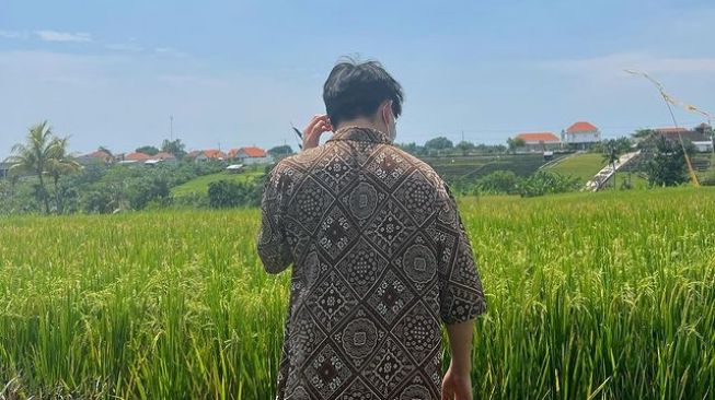 Rich Brian berfoto di pinggir sawah (Instagram/@brianimanuel)