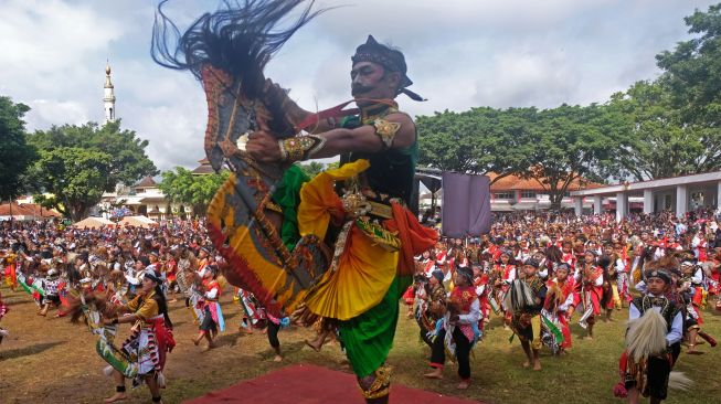 Sejumlah pelajar menampilkan tari Jaran Kepang massal saat pentas Banjaran Jaran Kepang di alun-alun kota Temanggung, Jawa Tengah, Minggu (27/11/2022). [ANTARA FOTO/Anis Efizudin/aww]
