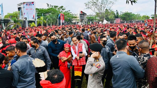 Presiden Joko Widodo (tengah) berswafoto dengan seorang prajurit Pasukan Merah Tariu Borneo Bangkule Rajakng (TBBR) saat menghadiri acara temu akbar Pasukan Merah TBBR di Rumah Radakng, Pontianak, Kalimantan Barat, Selasa (29/11/2022). [Foto: Laily Rachev - Biro Pers Sekretariat Presiden]