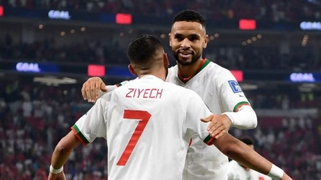 Pemain Maroko Youssef En-Nesyri dan Hakim Ziyech rayakan gol ke gawang Kanada di matchday ketiga Grup F Piala Dunia 2022 di Al Thumama Stadium, Kamis (1/12/2022). [AFP]
