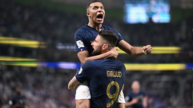 Penyerang Prancis Olivier Giroud merayakan dengan penyerang Prancis Kylian Mbappe setelah berhasil mencetak gol saat pertandingan sepak bola babak 16 besar Piala Dunia 2022 antara Prancis dan Polandia di Stadion Al-Thumama, Doha, Qatar, Minggu (4/12/2022). [Kirill KUDRYAVTSEV / AFP]