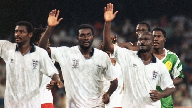 Para pemain timnas Kamerun (dari kiri) François Omam Biyick, Stephen Tataw dan Roger Milla melambaikan tangan kepada para penggemar mereka pada akhir pertandingan perempat final Piala Dunia 1990 antara Inggris vs Kamerun pada 01 Juli 1990 di Naples. Kamerun tersingkir dari turnamen kalah dari Inggris 3-2 di perpanjangan waktu. AFP FOTO/GEORGES GOBET