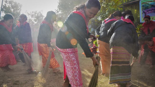 Sejumlah perempuan dewasa (mata ina) mengenakan kebaya ambon saat proses membersihkan baileo samasuru pada puncak tradisi Cuci Negeri di Negeri (Desa) Soya, Kota Ambon, Provinsi Maluku, Jumat (9/12/2022). [ANTARA FOTO/FB Anggoro/nz]