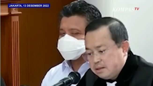 Ferdy Sambo tampak tersenyum dan geleng-geleng kepala saat penasihat hukumnya, Arman Hanis, berdebat panas soal kebohongan Bharada E alias Richard Eliezer Pudihang Lumiu di persidangan, Rabu (13/12/2022). (YouTube/KOMPASTV)