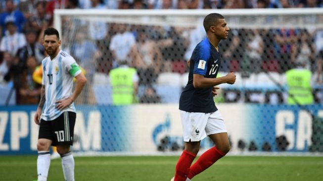 Penyerang timnas Prancis Kylian Mbappe (kanan) meninggalkan lapangan saat disaksikan penyerang Argentina Lionel Messi selama babak 16 besar Piala Dunia 2018 Rusia antara Prancis vs Argentina di Kazan Arena di Kazan pada 30 Juni 2018.FRANCK FIFE / AFP.