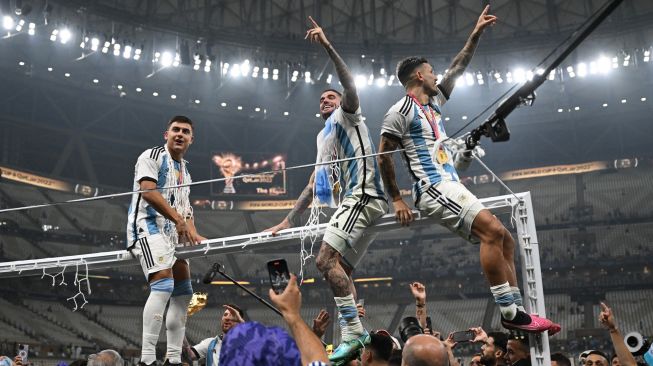 (Kiri-kanan) Penyerang Argentina Paulo Dybala, gelandang Rodrigo De Paul dan Leandro Paredes selebrasi usai upacara penghargaan dan setelah memenangkan memenangkan pertandingan sepak bola final Piala Dunia 2022 antara Argentina dan Prancis di Stadion Lusail di Lusail, utara Doha, Qatar, Minggu (18/12/2022). [FRANCK FIFE / AFP]