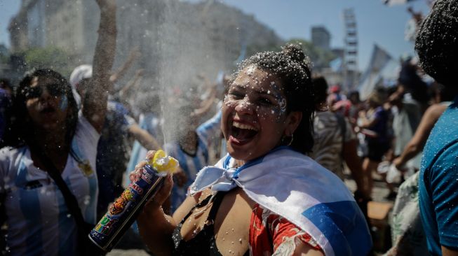 Fans Argentina berkumpul di Tugu Obelisk untuk merayakan kemenangan Piala Dunia Qatar 2022 melawan Prancis di Buenos Aires, Argentina, Minggu (18/12/2022). [Emiliano Lasalvia / AFP]