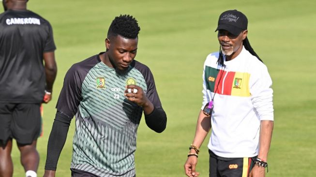 Andre Onana dan Pelatih Kamerun Rigobert Song berbincang di sela-sela latihan di Sailiya, Doha, Qatar, pada 27 November 2022. [AFP]