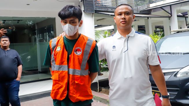 Aktor Revaldo Fifaldi dibawa petugas untuk dihadirkan saat rilis kasus narkoba yang menjeratnya di Polda Metro Jaya, Jakarta, Jumat (13/1/2023). [Suara.com/Alfian Winanto]