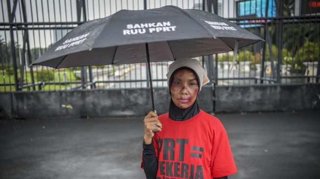 Pengunjuk rasa yang tergabung dalam Koalisi Sipil untuk UU PPRT menggelar aksi teaterikal di depan gedung DPR, Jakarta, Rabu (1/2/2023).[ANTARA FOTO/Galih Pradipta].