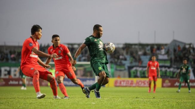 Pemain Persebaya Michael Rumere (kanan) mengontrol bola dengan dadanya saat melawan Borneo FC pada laga lanjutan Liga 1 Indonesia musim 2022/2023, di Stadion Gelora Joko Samudro, Gresik, Jumat (3/2/2023). (ANTARA/Rizal Hanafi)