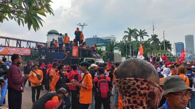 Massa buruh saat demonstrasi di depan Gedung MPR/DPR RI, Jakarta. (Suara.com/Yaumal)