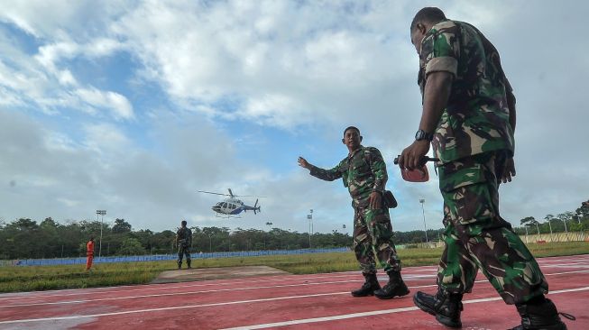 Tim SAR gabungan TNI, Polri, dan Basarnas berjaga saat proses pendaratan Helikopter Bell 429 milik Polri yang digunakan dalam proses evakuasi kecelakaan heli Kapolda Jambi di Stadion Merangin, Jambi, Selasa (21/2/2023). [ANTARA FOTO/Wahdi Septiawan].