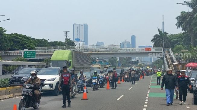 Penampakan jalan di Gatot Subroto saat massa buruh menggelar unjuk rasa di depan Gedung DPR RI, Jakarta. (Suara.com/Rakha)