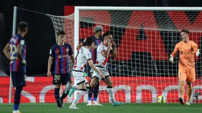 Gelandang Rayo Vallecano Alvaro Garcia Rivera (tengah) merayakan golnya pada pertandingan sepak bola liga Spanyol antara Rayo Vallecano de Madrid dan FC Barcelona di stadion Vallecas di Madrid pada 26 April 2023. Pierre-Philippe MARCOU / AFP