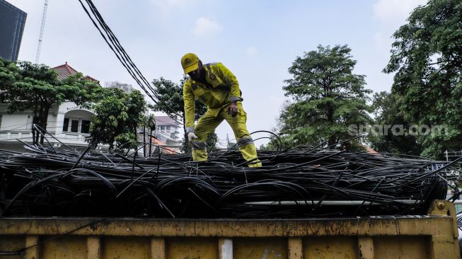 Petugas Dinas Bina Marga DKI Jakarta melakukan penataan kabel utilitas di sekitar Jalan Haji Agus Salim, Jakarta Pusat, Rabu (24/5/2023). [Suara.com/Alfian Winanto]