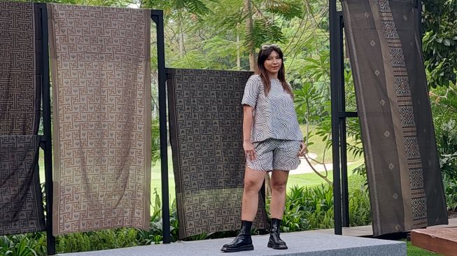 Desainer Bai Soemarlono tampil beda dengan membuat karya baju memakai bahan kain tenun. (Dok. Lilis/Suara.com)