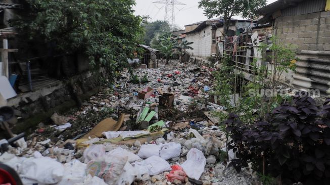 Tumpukan sampah memenuhi Sodetan kali yang terbengkalai di Kampung Sumur, Klender, Jakarta Timur, Kamis (1/6/2023). [Suara.com/Alfian Winanto]