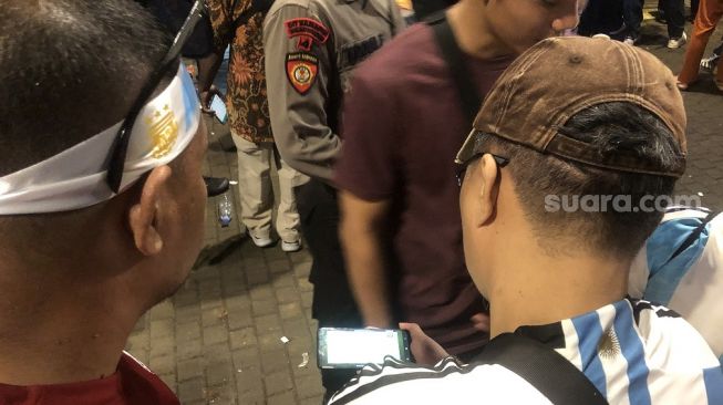 Suporter menyaksikan pertandingan Timnas Indonesia vs Argentina secara streaming di luar Stadion Utama Gelora Bung Karno, Senin (19/6/2023). [Suara.com/ Faqih Fathurrahman]