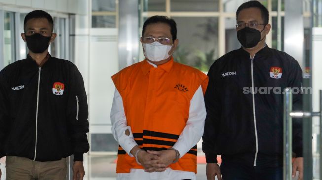 The suspected secretary of the Supreme Court (MA) Hasbi Hasan wore a prisoner's outfit when presented at a press conference announcing the detention of the suspect at the KPK's Red and White Building, Newsdelivers.com, Wednesday (12/7/2023).  (Suara.com/Alfian Winanto)