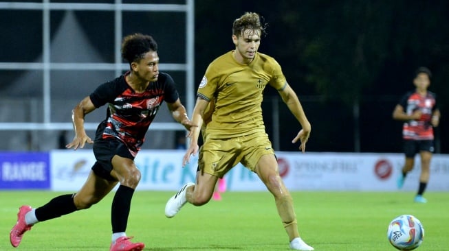 Pesepak bola Garuda United U-17 Zulkifli Lukmansyah (kiri) berebut bola dengan pesepak bola Barcelona Juvenil A Cristobal Munoz Lopez (kanan) saat pertandingan uji coba di Stadion I Gusti Ngurah Rai, Denpasar, Bali, Rabu (2/8/2023). ANTARA FOTO/Fikri Yusuf/aww. 