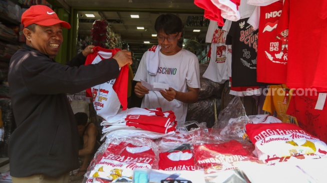 Warga memilih pernak-pernik merah putih untuk HUT RI ke-78 di Kawasan Pasar Mester Jatinegara, Jakarta, Selasa (8/8/2023). [Suara.com/Alfian Winanto]