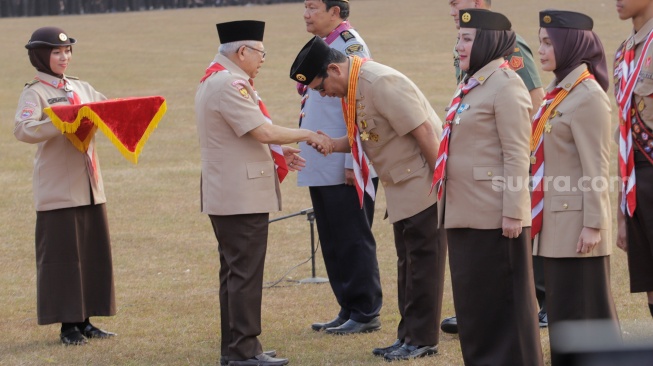 Wakil Presiden Republik Indonesia Ma'ruf Amin memberikan lencana penghargaan saat upacara pembukaan Raimuna Nasional (Rainas) XII di Bumi Perkemahan Cibubur, Jakarta, Senin (14/8/2023). [Suara.com/Alfian Winanto]