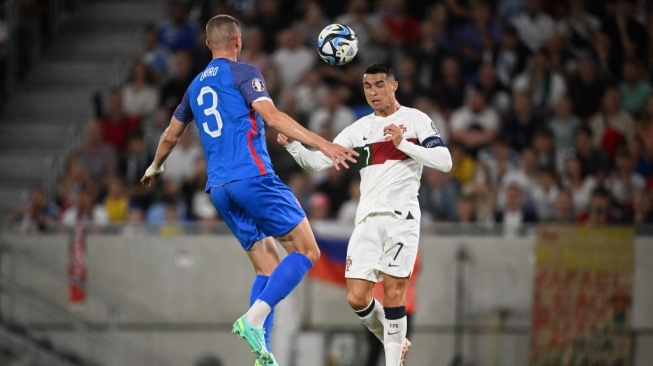Portugal national team striker Cristiano Ronaldo (right) and Slovakia defender Denis Vavro jump to head the ball during matchday 5 of Group J of UEFA EURO 2024 qualifying between Slovakia vs Portugal in Bratislava on September 8, 2023. VLADIMIR SIMICEK / AFP