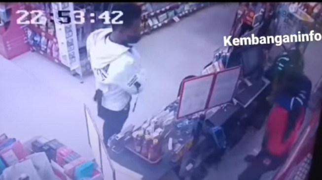 Perampok di minimarket kawasan Jakarta Barat terekam CCTV saat piting hingga cekik kasir. (tangkapan layar/ist)