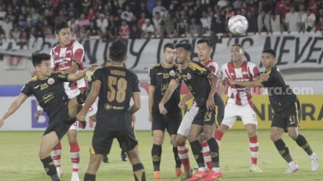 Pemain Persis Solo, Althaf Indie (tengah) menyundul bola ke gawang Persija Jakarta dalam lanjutan pekan ke-14 BRI Liga 1 2023/2024 di Stadion Manahan, Sabtu (30/9/2023). [Suara.com/Ronald Seger Prabowo]