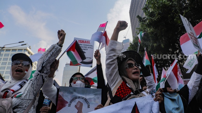 Massa aksi melakukan unjuk rasa di depan kantor perwakilan Perserikatan Bangsa-Bangsa (PBB) di Jakarta, Jumat (20/10/2023). [Suara.com/Alfian Winanto]