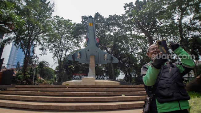 Warga berswafoto dengan latar belakang Monumen Swa Bhuwana Paksa, Tebet, Jakarta, Kamis (2/11/2023). [Suara.com/Alfian Winanto]