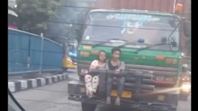 Viral Sejoli Duduk Berduaan di Bumper Depan Truk Kontainer, Warganet: Dunia Milik Berdua