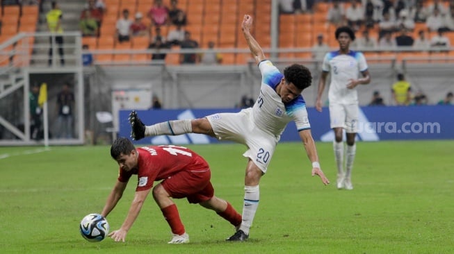 Pesepak bola Timnas Inggris U-17 Nwaneri Ethan  berebut bola dengan Pemain Timnas Iran U-17 Sadeghi Mahan pada pertandingan Grup C Piala Dunia U-17 2023 di Jakarta International Stadium (JIS), Jakarta, Selasa (14/11/2023). [Suara.com/Alfian Winanto]