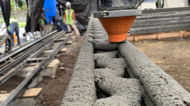 Proses pencetakan dinding bangunan menggunakan teknologi 3D Construction Printing yangdikembangkan oleh Autoconz.