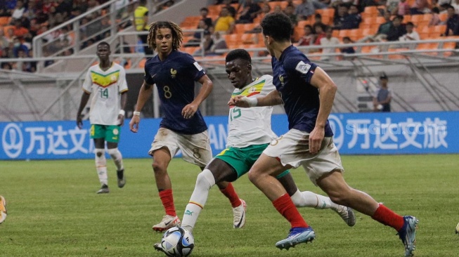 Pesepak bola Timnas Senegal U-17 Mamadou Gning berusaha melewati pemain Timnas Prancis U-17 dalam  pertandingan babak 16 besar Piala Dunia U-17 2023 di Jakarta International Stadium (JIS), Jakarta, Rabu (22/11/2023). [Suara.com/Alfian Winanto]