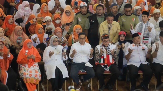 Calon Presiden (Capres) Nomor Urut 1 Anies Baswedan (tengah) melakukan doa bersama dengan para pendukungnya saat menggelar kampanye perdana di GOR Ciracas, Jakarta, Selasa (28/11/2023). [Suara.com/Alfian Winanto]