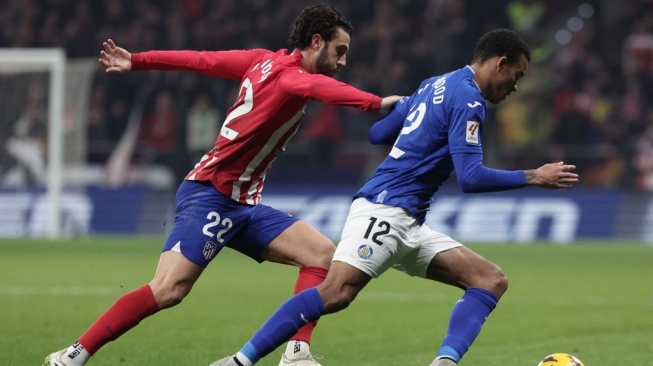 Penyerang sayap Getafe pinjaman dari Manchester United, Mason Greenwood (kanan) tampil dalam laga Liga Spanyol kontra Atletico Madrid di Stadion Wanda Metropolitano, Madrid, Rabu (20/12) dini hari WIB. [Thomas COEX / AFP]