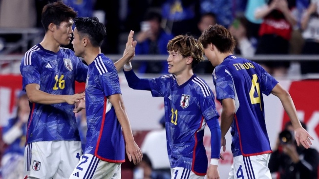Para pemain Timnas Jepang. [PAUL MILLER / AFP]