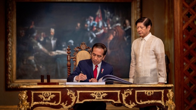 Presiden Indonesia Joko Widodo, bersama Presiden Filipina Ferdinand Marcos Jr. mengunjungi buku tamu saat kunjungannya di Istana Malacanang, di Manila, Filipina, Rabu (10/1/2024). [Ezra Acayan/Pool/AFP]