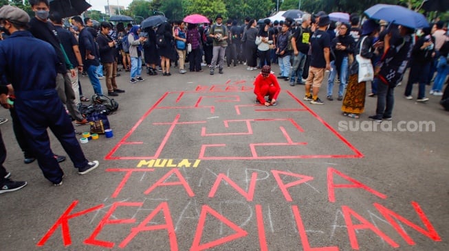 Aktivis mengikuti aksi 17 Tahun Aksi Kamisan di depan Istana Negara, Jakarta, Kamis (18/1/2024). [Suara.com/Alfian Winanto]